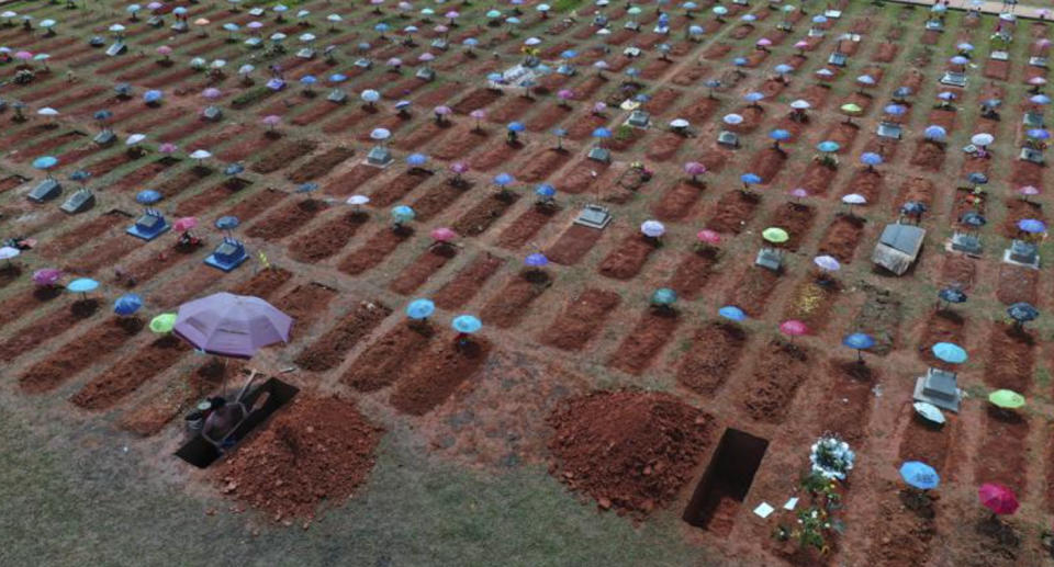 A worker digs a grave in the San Juan Bautista cemetery in Iquitos, Peru.