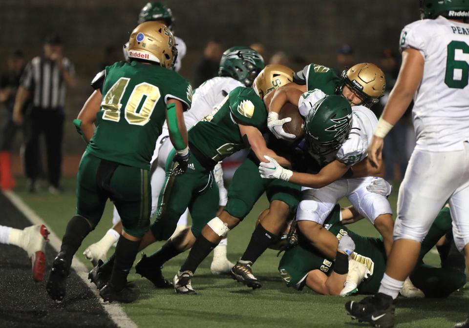 Pacifica's Philip Kim fights through the St. Bonaventure defense to score a touchdown in the second quarter of the nonleague showdown at Ventura College on Friday, Aug. 26, 2022. St. Bonaventure rallied for a 46-41 win.