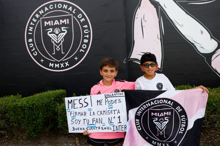 Young fans hold a sign asking <a class="link " href="https://sports.yahoo.com/soccer/players/372884" data-i13n="sec:content-canvas;subsec:anchor_text;elm:context_link" data-ylk="slk:Lionel Messi;sec:content-canvas;subsec:anchor_text;elm:context_link;itc:0">Lionel Messi</a> to sign their shirt outside DRV PNK Stadium in Fort Lauderdale, Florida, where the Argentine star was to be presented as the newest player for Major League Soccer's Inter Miami (Eva Marie UZCATEGUI)