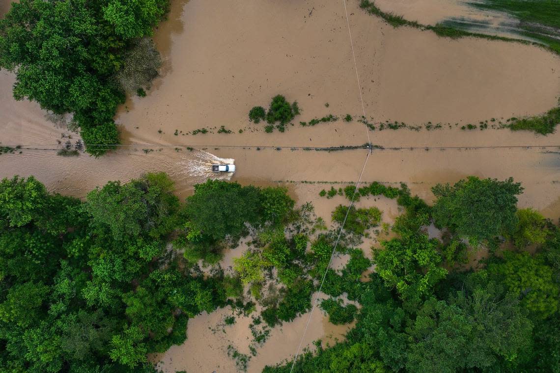 A truck drives along flooded Wolverine Road in Breathitt County, Ky., on Thursday, July 28, 2022.