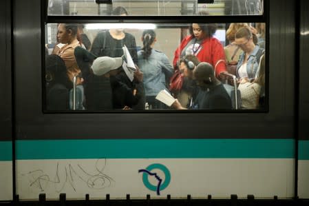 Commuters are seen in a metro at the Gare du Nord subway station during a strike by all unions of the Paris transport network (RATP) against pension reform plans in Paris