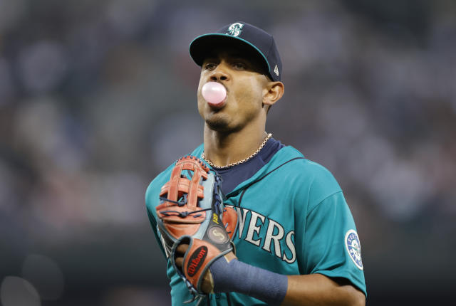 Seattle Mariners' Cal Raleigh wears the Home Run helmet after hitting a two-run  home run off Cleveland Guardians relief pitcher Trevor Stephan during the  eleventh inning of a baseball game in Cleveland