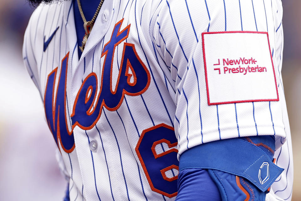 New York Mets' Starling Marte heads to the dugout during the fourth inning of a baseball game against the Miami Marlins on Friday, April 7, 2023, in New York. In a partnership with NewYork-Presbyterian Hospital, the team wore advertisements on its jersey sleeves for the first time during Friday's home opener against the Miami Marlins. (AP Photo/Adam Hunger)