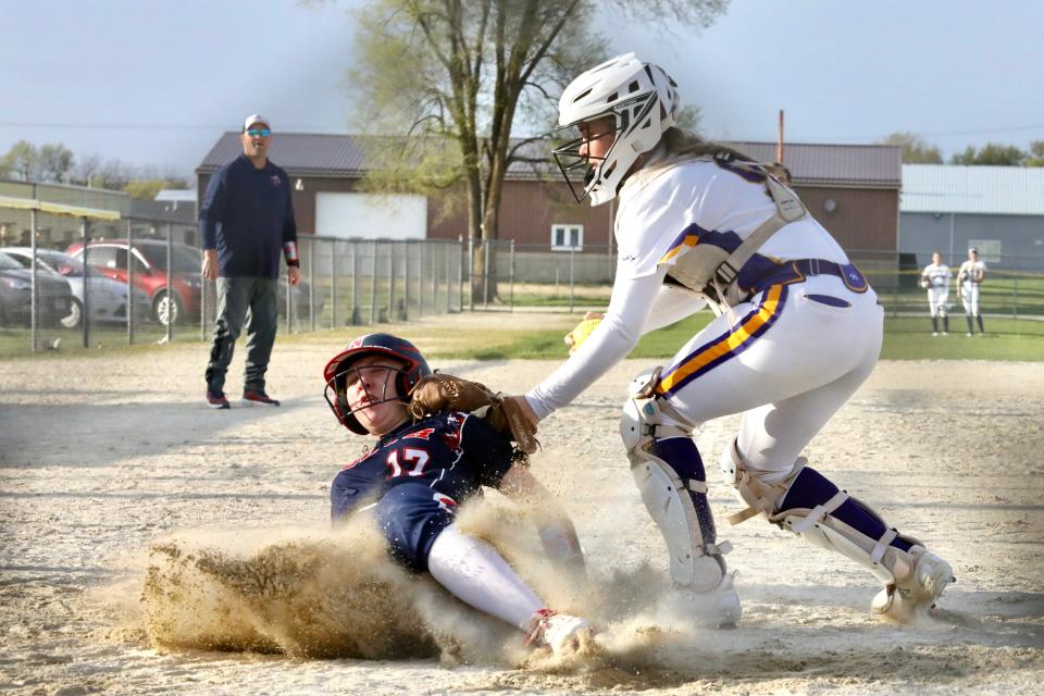 Hononegah catcher Dani Franz tries to tag a sliding Johnson Paige of Belvidere North. Paige scored safely, but Hononegah rolled to the 10-5 win on Monday, April 22, 2024, in Roscoe.