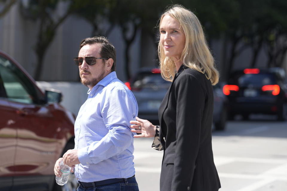Juan Henao walks with attorney Courtney Caprio following a federal court hearing into the disappearance of his sister Ana Maria Henao Knezevich, Friday, May 10, 2024, in Miami. David Knezevich was denied bond after he was arrested and charged with kidnapping in the disappearance of his wife, Ana Maria Henao Knezevich from her apartment in Spain. (AP Photo/Marta Lavandier)
