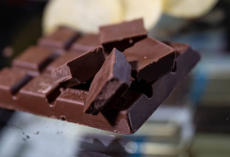 A Chocolate bar lies on a table. Since the price of a ton of raw cocoa on the London commmodity exchange recently climbed to a record high of just under €5,500 ($5,960), chocolate fans have reason to be alarmed. Hendrik Schmidt/dpa