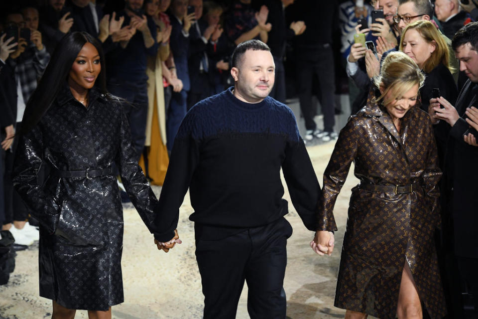 <p>The men’s artistic director of Louis Vuitton, Kim Jones, takes his final walk following his catwalk show in Paris, joined by supermodels Naomi Campbell and Kate Moss. (Photo: Getty Images) </p>