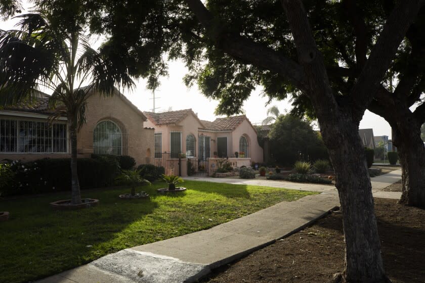 LOS ANGELES, CA - DECEMBER 01: A poll of LA County voters' positions on new state laws that take effect Jan. 1 that allow for duplexes, and in some cases fourplexes, in single-family home neighborhoods such as this South Los Angeles neighborhood, show that they are in favor. The new housing that will be allowed will look very much like accessory dwelling units. Photographed on Wednesday, Dec. 1, 2021. (Myung J. Chun / Los Angeles Times)