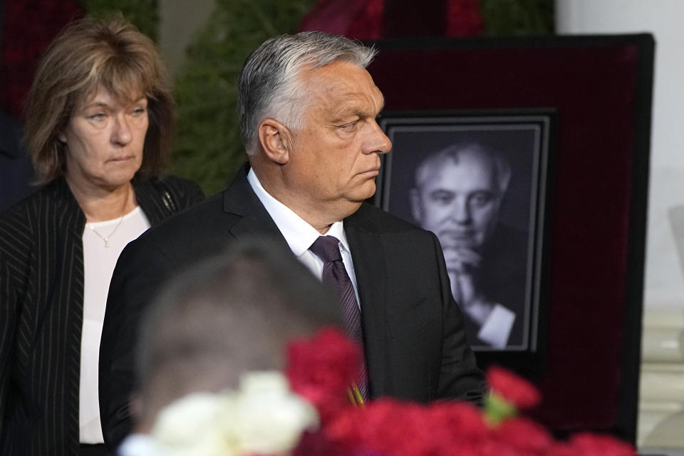 Hungary's Prime Minister Viktor Orban walks to the coffin of former Soviet President Mikhail Gorbachev inside the Pillar Hall of the House of the Unions during a farewell ceremony in Moscow, Russia, Saturday, Sept. 3, 2022. Gorbachev, who died Tuesday at the age of 91, will be buried at Moscow's Novodevichy cemetery next to his wife, Raisa, following a farewell ceremony at the Pillar Hall of the House of the Unions, an iconic mansion near the Kremlin that has served as the venue for state funerals since Soviet times. (AP Photo/Alexander Zemlianichenko)