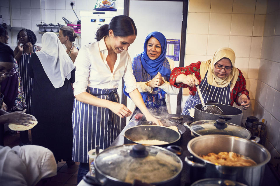 The Duchess of Sussex cooking with women in the Hubb Community Kitchen at the Al Manaar Muslim Cultural Heritage Centre in West London, in the aftermath of the Grenfell Tower fire.  (Jenny Zarins for PA Wire/PA Images)