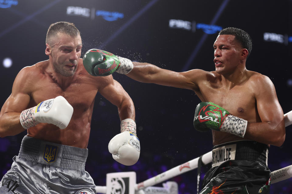 David Benavidez, right, lands a right to Oleksandr Gvozdyk during an interim light heavyweight boxing bout Saturday, June 15, 2024, in Las Vegas. (Ellen Schmidt/Las Vegas Review-Journal via AP)