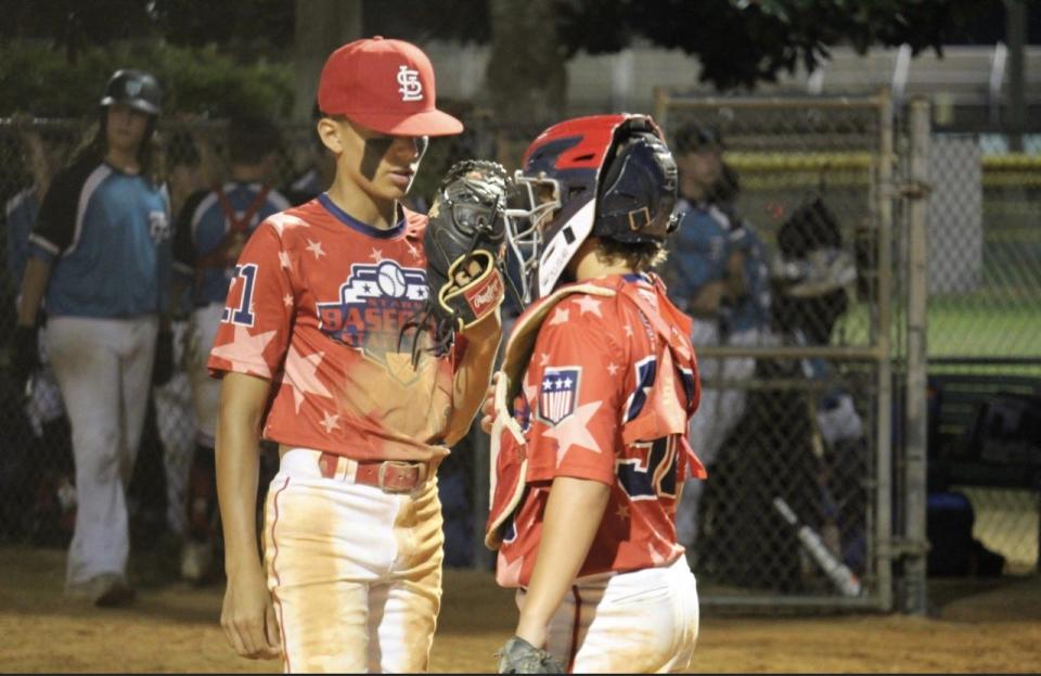 State Line Stars 13U catcher Jett Smith (right) talks to pitcher Ray Campos during a game earlier this summer.