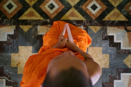 A buddhist monk prays at Wat Benchamabophit (Marble Temple) in Bangkok, Thailand August 24, 2017. REUTERS/Athit Perawongmetha