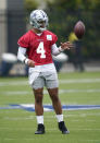 Dallas Cowboys quarterback Dak Prescott (4) tosses the ball during an NFL football team practice Wednesday, June 9, 2021, in Frisco, Texas. (AP Photo/LM Otero)