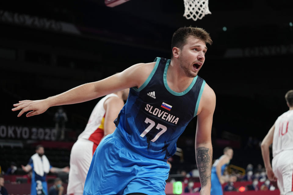 Slovenia's Luka Doncic (77) reacts to a play during a men's basketball preliminary round game against Spain at the 2020 Summer Olympics, Sunday, Aug. 1, 2021, in Saitama, Japan. (AP Photo/Eric Gay)