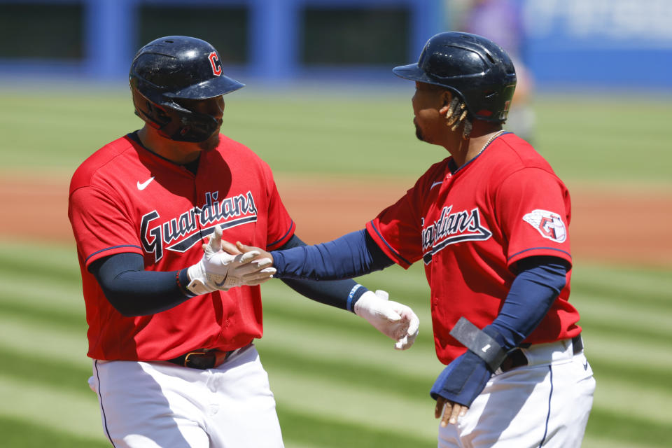 Cleveland Guardians designated hitter Josh Naylor, left, celebrates with Jose Ramirez after hitting a two-run home run off Colorado Rockies starting pitcher German Marquez during the first inning of a baseball game, Wednesday, April 26, 2023, in Cleveland. (AP Photo/Ron Schwane)