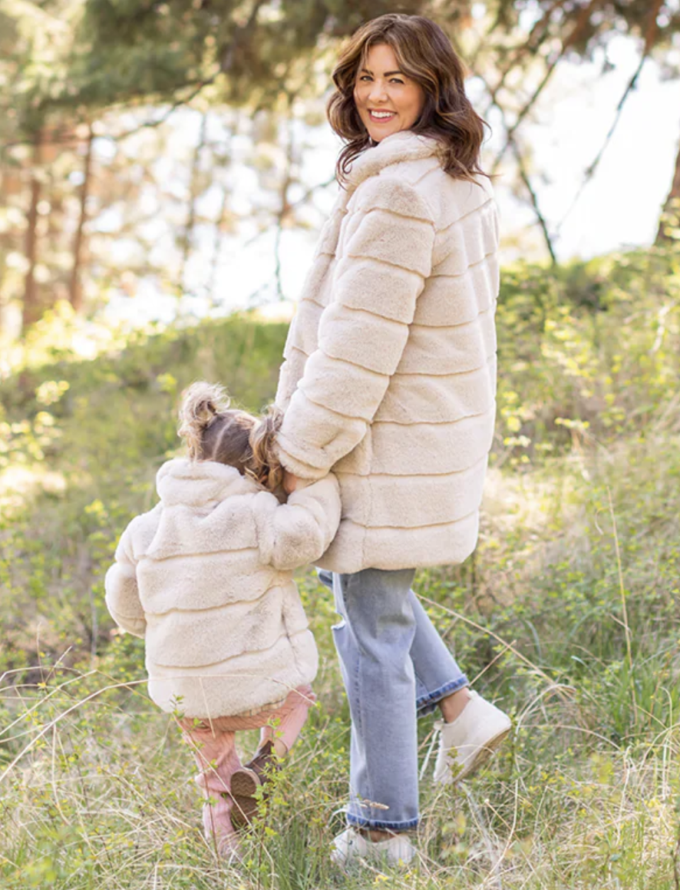 Jillian Harris and her daughter Annie wearing matching Harris Coats outside in grass