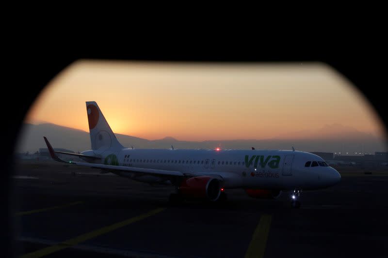 FILE PHOTO: A VivaAerobus aircraft sits on the tarmac as seen from inside another plane, at Benito Juarez international airport in Mexico City