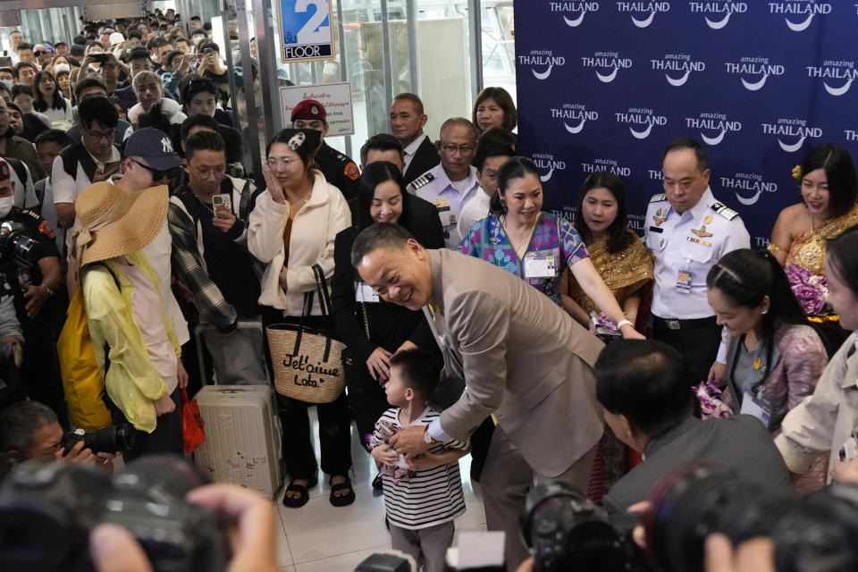 FILE - Chinese boy tourists are welcomed by Thailand's Prime Minister Srettha Thavisin, right, on their arrivals at Suvarnabhumi International Airport in Samut Prakarn province, Thailand, Monday, Sept. 25, 2023. Thailand and China will soon implement visa-free entry for each other’s citizens, Thai Prime Minister Srettha Thavisin said Tuesday, Jan. 2, 2024.(AP Photo/Sakchai Lalit, File)