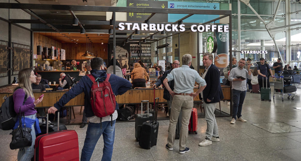 Arriving travelers are seen with their luggage outside Starbucks Coffee in the arrivals hall at Terminal 1 in Humberto Delgado International Airport on October 07, 2022 in Lisbon, Portugal.  (Photo by Horacio Villalobos#Corbis/Corbis via Getty Images)