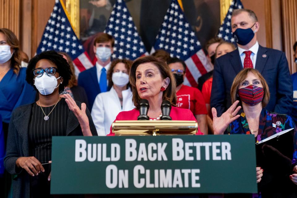 House Speaker Nancy Pelosi, D-Calif., accompanied by other House Democrats and climate activists, pauses while speaking about their "Build Back Better on Climate" plan on Capitol Hill in Washington on Sept. 28, 2021.