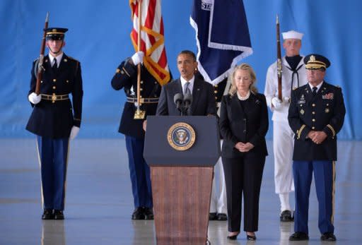 US President Barack Obama (C) speaks as Secretary of State Hillary Clinton looks on during the transfer of remains ceremony marking the return to the US of the remains of the four Americans killed in an attack this week in Benghazi, Libya, at the Andrews Air Force Base in Maryland