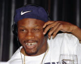 FILE - In this April 9, 1997, file photo, WBC welterweight champion Pernell Whitaker adjusts his head phones during a news conference in Las Vegas. Former boxing champion Pernell Whitaker has died after he was hit by a car in Virginia. He was 55. Police in Virginia Beach on Monday say Whitaker was a pedestrian when struck by the car Sunday night, July 14, 2019. The driver remained on the scene, where Whitaker was pronounced dead. (AP Photo/Lennox McLendon, File)