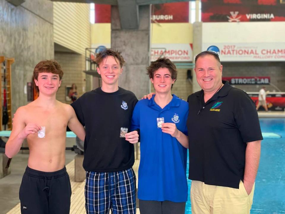 Lexington Catholic diving coach Jamie Palumbo poses with his boys team, from left, Graham Leslie, Jett Vanderhorst and Miles Buchart after the Region 8 Diving Championships at the University of Louisville on Monday. Photo provided