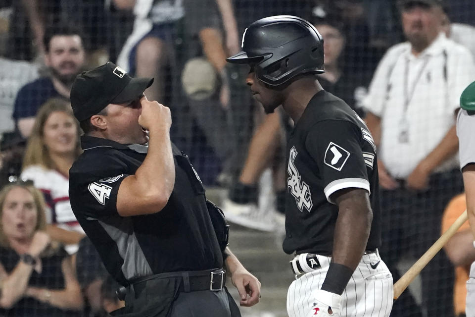Home plate umpire Nick Mahrley reacts after Chicago White Sox's Tim Anderson made contact with Mahrley during the seventh inning of a baseball game Friday, July 29, 2022, in Chicago. Anderson was ejected. (AP Photo/Charles Rex Arbogast)