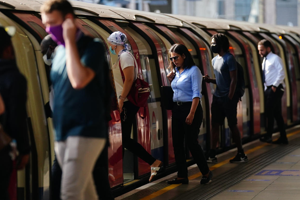 Commuters, some not wearing facemasks, getting on a Jubilee Line train at 0843 at Canning Town station, London, after the final legal Coronavirus restrictions were lifted in England. Picture date: Monday July 19, 2021. (Photo by Victoria Jones/PA Images via Getty Images)