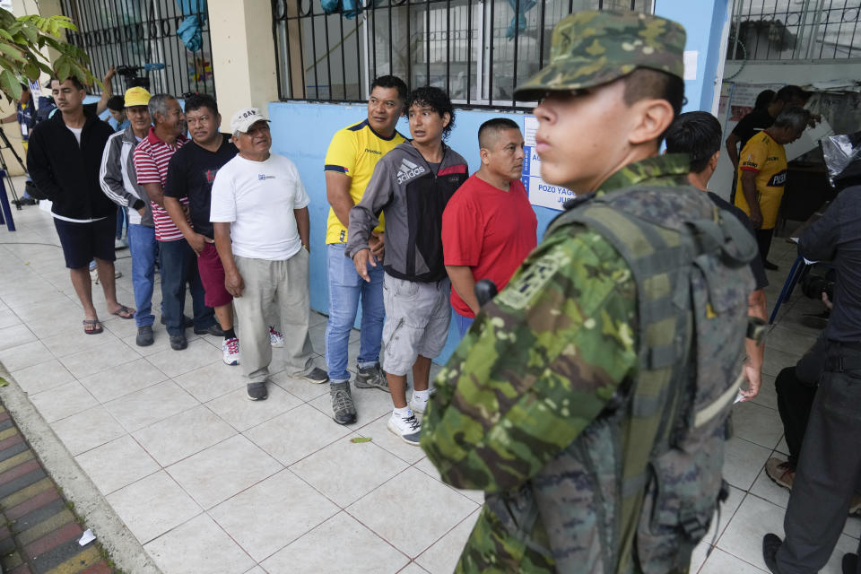 Voters line up at a polling station during a runoff presidential election in Olon, Ecuador, Sunday, Oct. 15, 2023. (AP Photo/Martin Mejia)
