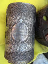 This image released by Egypt's Ministry of Antiquities on Friday, April 18, 2014 shows a cylindrical wooden box plated in silver, which would have held Torah scrolls from a cache of Jewish religious artifacts seized by officials in Damietta, Egypt that smugglers wanted to ship to Belgium at one of the country's main ports. Antiquities Minister Mohammed Ibrahim said in a statement Friday that officials found the artifacts while searching cargo Thursday at the coastal city of Damietta. Officials also found a silver knife dating to roughly 1890 with inscriptions, and bells commonly hung in synagogues. (AP Photo/Egypt Ministry of Antiquities)