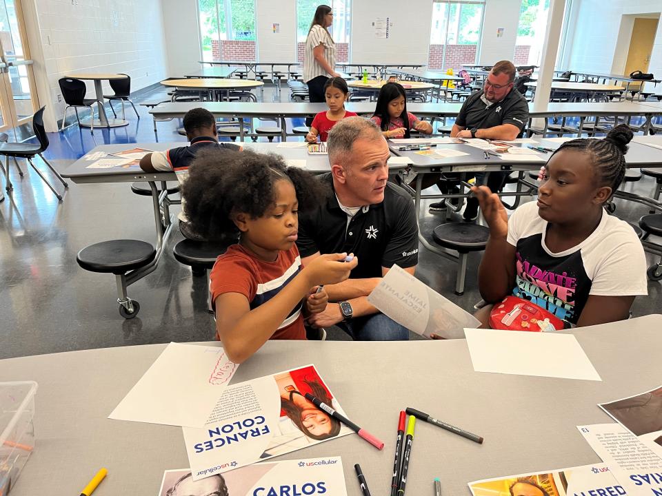 UScellular’s Thomas White listens as Iyah Groce describes her plans for artwork for the first Hispanic Heritage Art Contest at the Lonsdale location of the Boys & Girls Club of the Tennessee Valley. Malejah Marsh (left) is also doing some creative thinking. Aug. 31, 2023