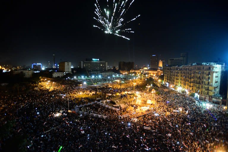 Fireworks light the sky as thousands of Egyptians gather to demonstrate against President Mohamed Morsi and the Muslim Brotherhood in Cairo's landmark Tahrir Square late on June 28, 2013. Washington warned against travel to Egypt after an American was among three people killed during rival demonstrations for and against Morsi ahead of Sunday's anniversary of his turbulent maiden year in office