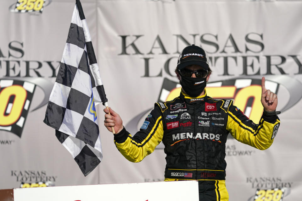 Brandon Jones celebrates after winning a NASCAR Xfinity Series auto race at Kansas Speedway in Kansas City, Kan., Saturday, July 25, 2020. (AP Photo/Charlie Riedel)