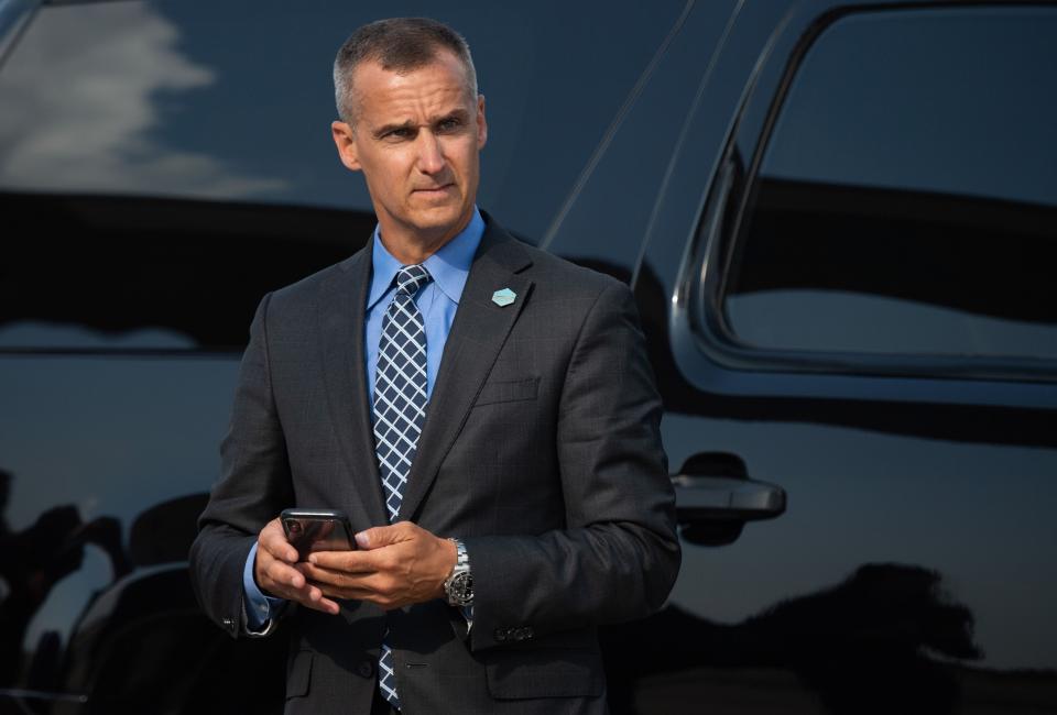 Corey Lewandowski, former campaign manager for President Donald Trump, watches as Trump disembarks from Air Force One upon arrival at Cincinnati/Northern Kentucky International Airport on Aug. 1.