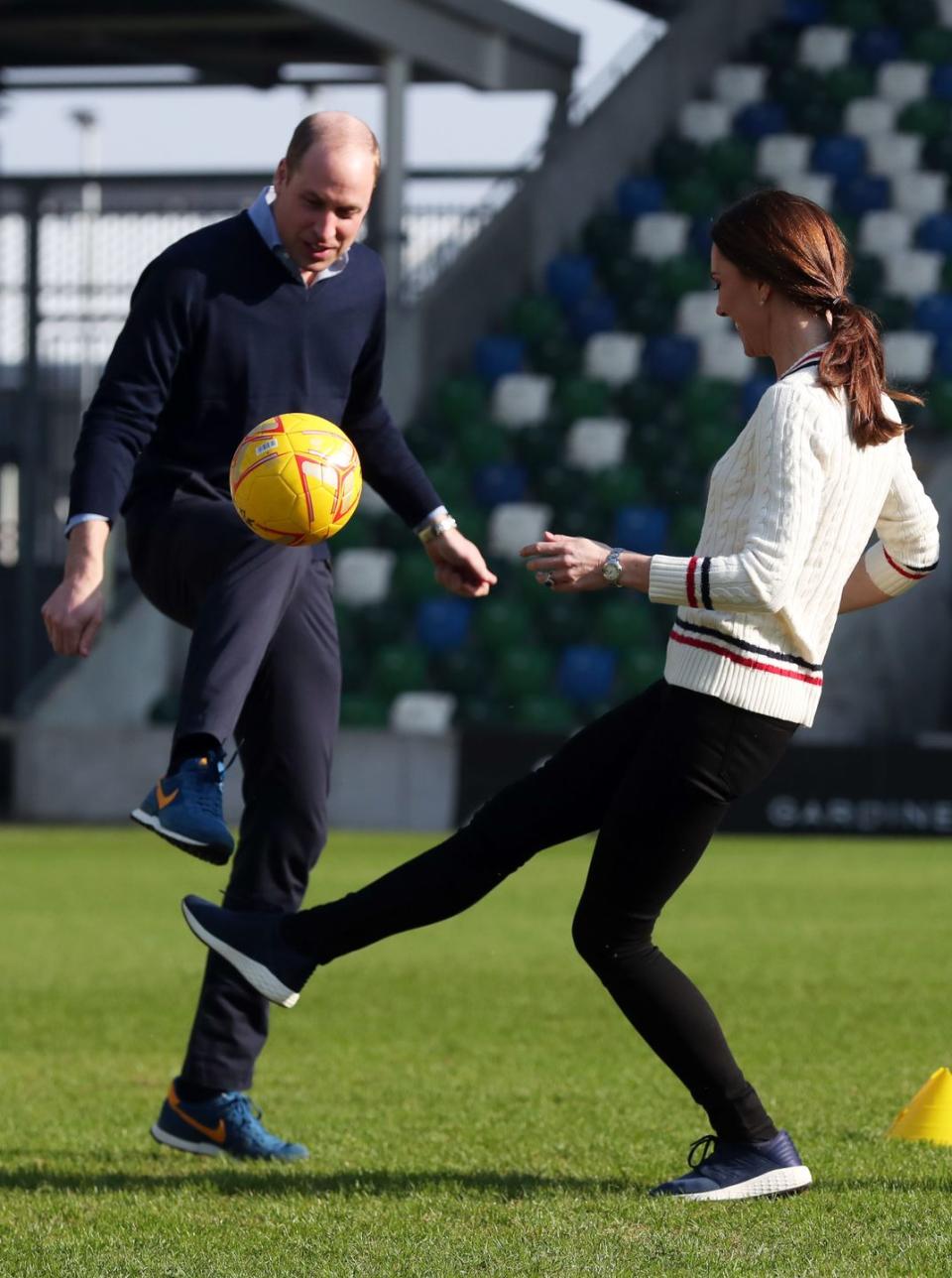 <p>The sporty couple enjoyed a game of football during their visit to the National Stadium in Belfast, February 2019. </p>