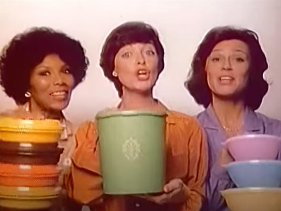 Three women holding Tupperware containers appear in a television ad for the brand in 1980.