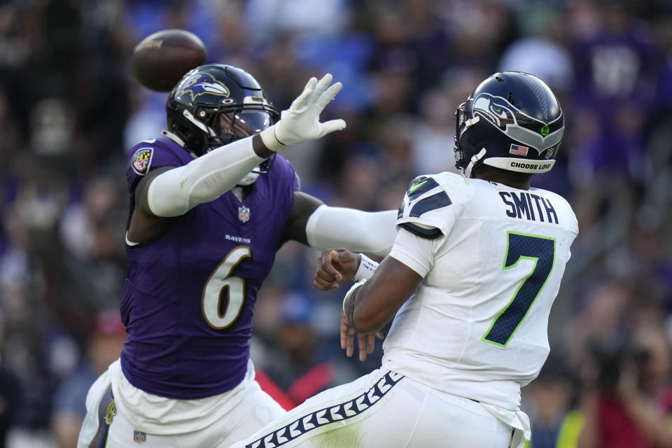Seattle Seahawks quarterback Geno Smith (7) passes over Baltimore Ravens linebacker Patrick Queen (6) during the second half of an NFL football game, Sunday, Nov. 5, 2023, in Baltimore. (AP Photo/Alex Brandon)