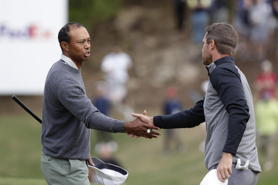Tiger Woods, left, shakes hands with Lucas Bjerregaard after their quarterfinal match at the Dell Technologies Match Play Championship golf tournament, Saturday, March 30, 2019, in Austin, Texas. Woods lost the match to Lucas Bjerregaard. (AP Photo/Eric Gay)
