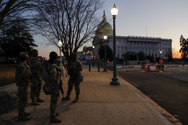 U.S. National Guard members stand near the U.S. Capitol Building on Capitol Hill in Washington