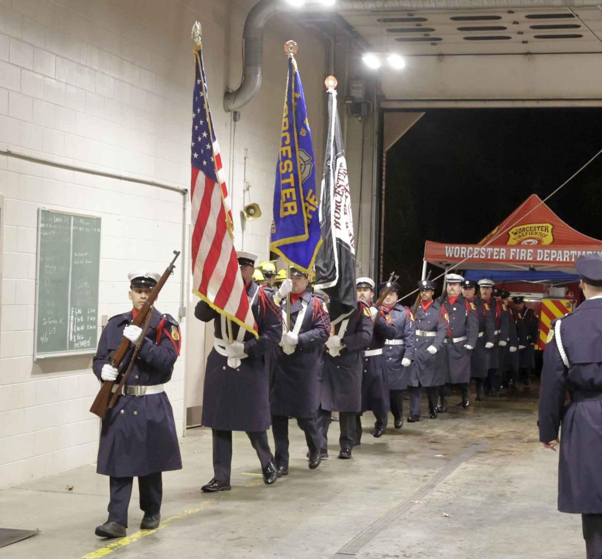 The procession for fallen Worcester Firefighter Lt. Jason Menard enters the McKeon Road Fire Station on Saturday.