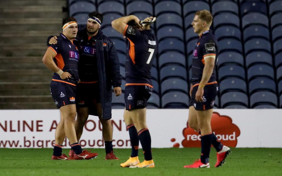 Edinburgh's Mike Willemse (left) is comforted by Stuart McInally at the end of the Guinness PRO14 Semi-Final - PA