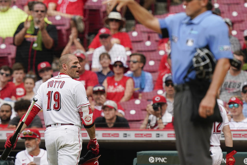 Cincinnati Reds' Joey Votto (19) looks back at the umpire during the fifth inning of a baseball game against the St. Louis Cardinals in Cincinnati, Sunday, July 25, 2021. (AP Photo/Bryan Woolston)