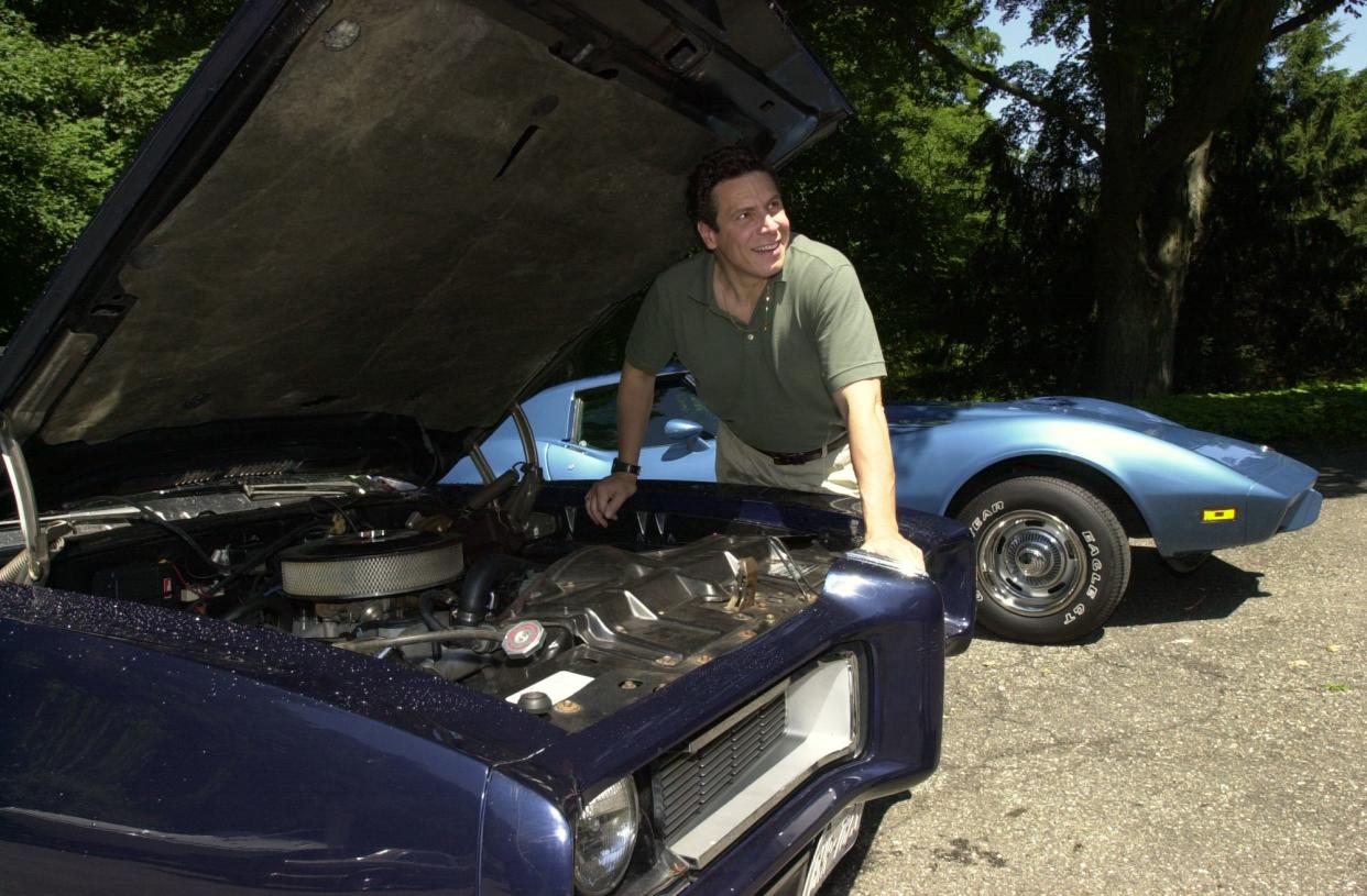 Gubernatorial hopeful Andrew Cuomo looks over his 1968 Pontiac GTO and his 1975 Corvette at his Mount Kisco, N.Y., home in 2002.