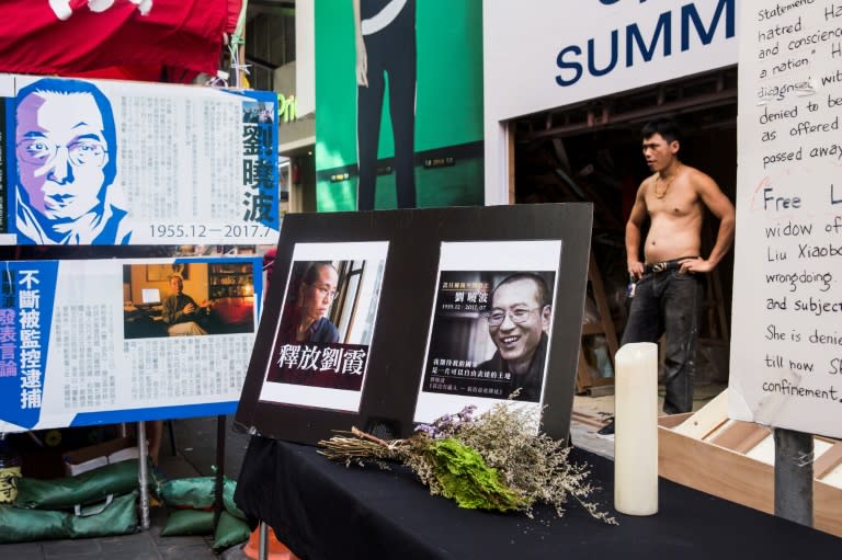 Activists in Hong Kong gave a minute's applause for Liu Xia, followed by a minute's silence at a memorial for the 1989 Tiananmen Square protest veteran Liu Xiaobo which was adorned with pictures of the couple