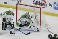 Dallas Stars goaltender Jake Oettinger (29) blocks a shot by Minnesota Wild left wing Marcus Johansson (90) during the third period of Game 4 of an NHL hockey Stanley Cup first-round playoff series Sunday, April 23, 2023, in St. Paul, Minn. (AP Photo/Stacy Bengs)