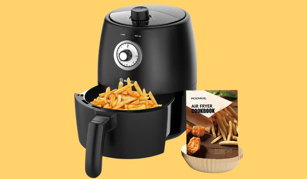 An air fryer, with french fries along with the Air Fryer Cookbook