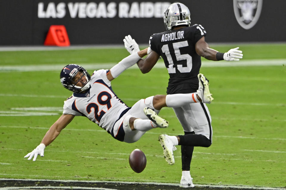 Las Vegas Raiders wide receiver Nelson Agholor (15) misses a pass while covered by Denver Broncos cornerback Bryce Callahan (29) during the first half of an NFL football game, Sunday, Nov. 15, 2020, in Las Vegas. (AP Photo/David Becker)