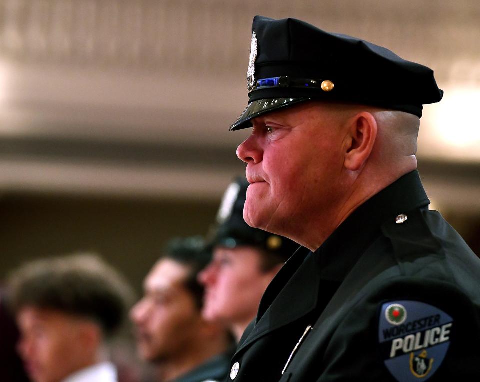 Carnegie Medal recipient Worcester police Officer Steven Barnett listens as Elvin Familia addresses the police officers who fought to save lives on the day that claimed the life of his brother, Worcester police Officer Enmanuel "Manny" Familia.